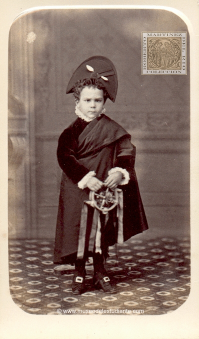 A child dressed as a tuno with tambourine