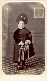 A child dressed as a tuno with tambourine