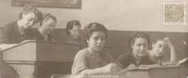 Female students take notes in the first classes opened in the liberated city